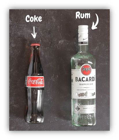 Image featuring a glass bottle of Coca-Cola on the left and a Bacardi Superior rum bottle on the right, both labeled with arrows. The background is a textured dark surface, highlighting the contrast between the two beverages.