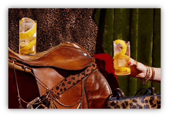 "Stylish saddle with drinks and leopard print backdrop."