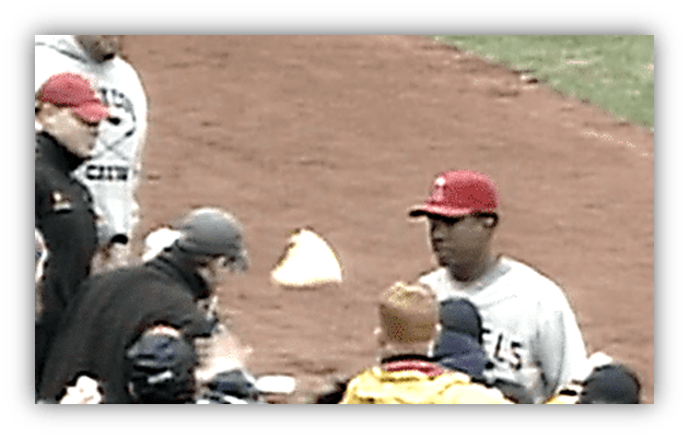 "Baseball players interacting on field during a game."