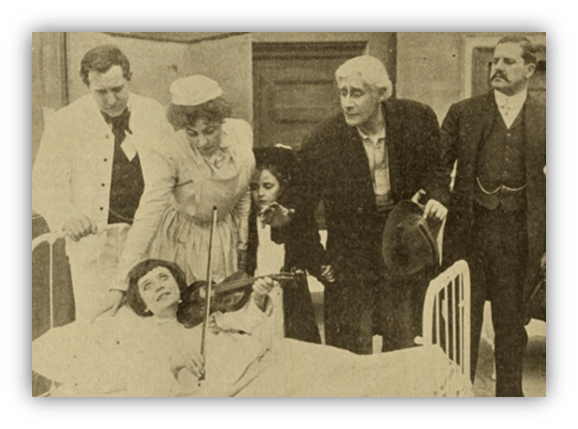 Vintage scene of actors performing in a hospital, featuring a woman playing violin in bed surrounded by onlookers.