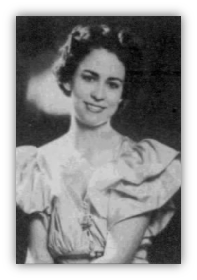 Black and white portrait of a smiling woman in a vintage dress with puffed sleeves.