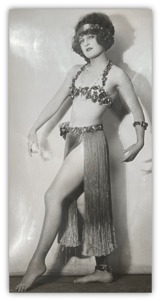 Vintage dancer in sparkling costume striking a pose.