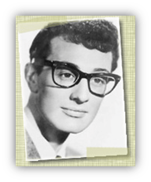 Black and white portrait of a young man with glasses, smiling softly.