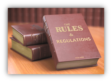 "Stack of law books titled 'The Rules & Regulations' on a wooden surface."