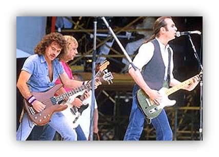 "Rock band performing live on stage with guitars and energetic poses."
