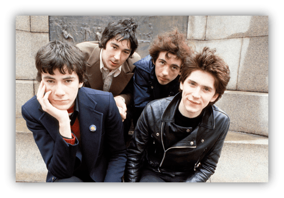 "Four young musicians posing together outdoors, showcasing a punk rock aesthetic."
