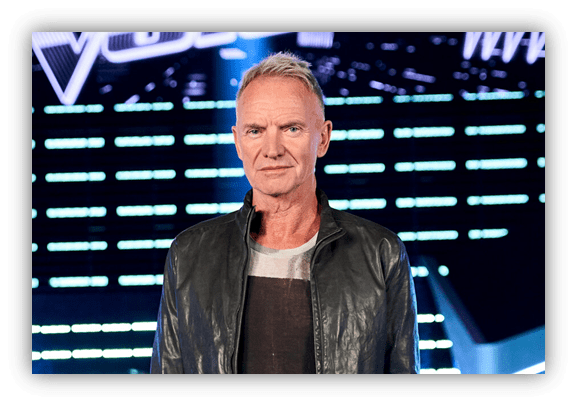 "Man in a leather jacket standing on a TV set with bright lights."