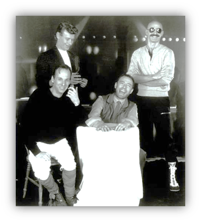 "Four men posing together in a vintage black and white photo, showcasing camaraderie and style."