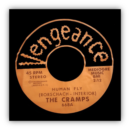 Alt text: "The Cramps 'Human Fly' 45 RPM record label on Vengeance Music."