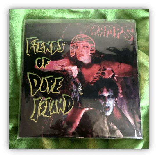 Album cover for "Fiends of Dope Island" by The Cramps, featuring bold graphics and striking imagery.