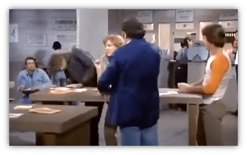 "Scene from a busy office with characters interacting at a reception desk."