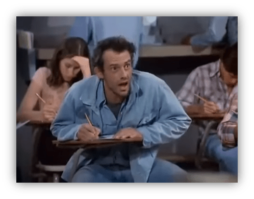 "Student looking surprised during a classroom exam, surrounded by classmates focused on their tests."