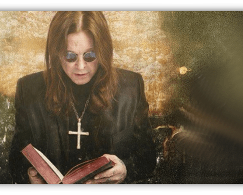"Person in sunglasses reading a book with a cross necklace, set against a textured background."