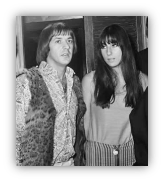 "Black and white photo of two musicians in vintage fashion, showcasing 1970s style."