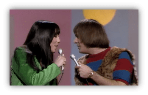 Cher and Sonny Bono performing a duet on stage.