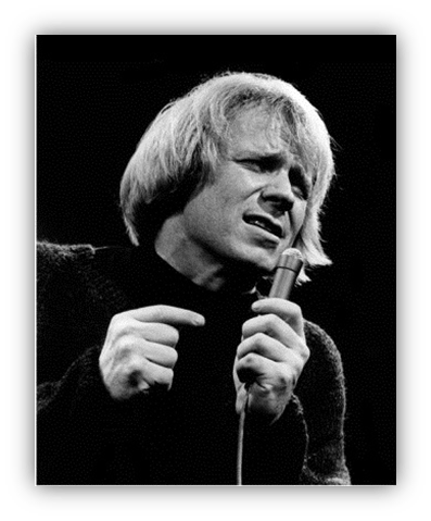 "Black and white image of a male singer passionately performing with a microphone."