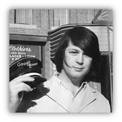 "Young man holding a Good Humor ice cream cap, 1970s vintage style."