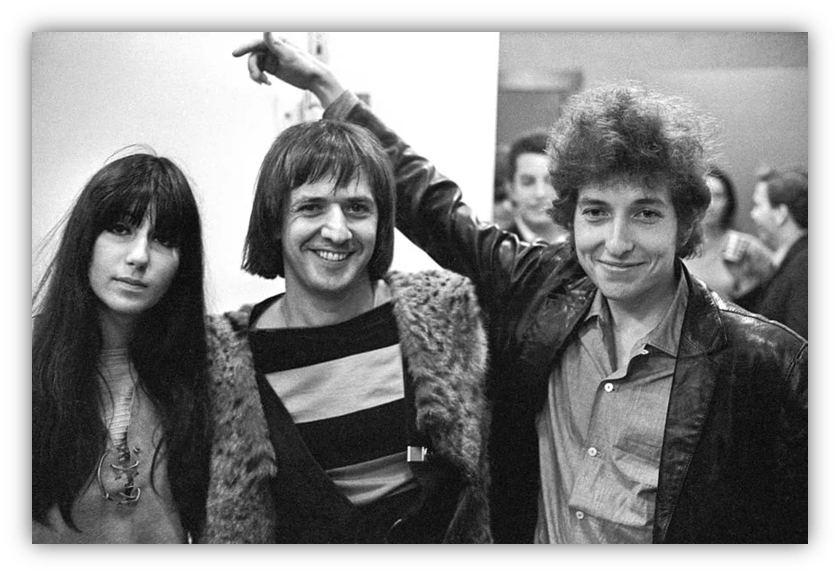 Black and white photo of three musicians posing together at an event.