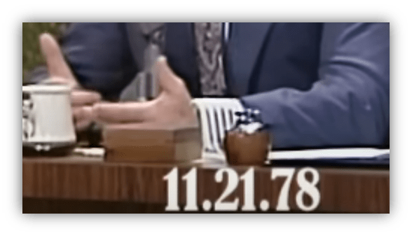 Person gesturing during a discussion on a talk show, with a date of 11.21.78 displayed.