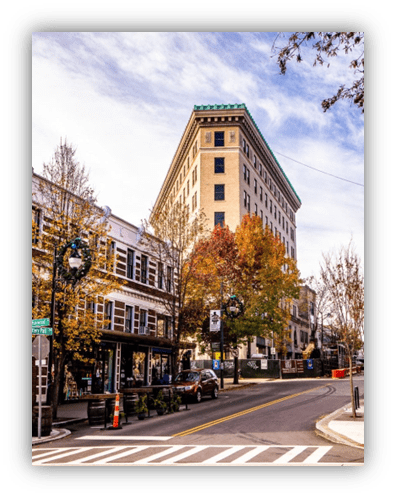 "Historic building in downtown with autumn trees and street view."