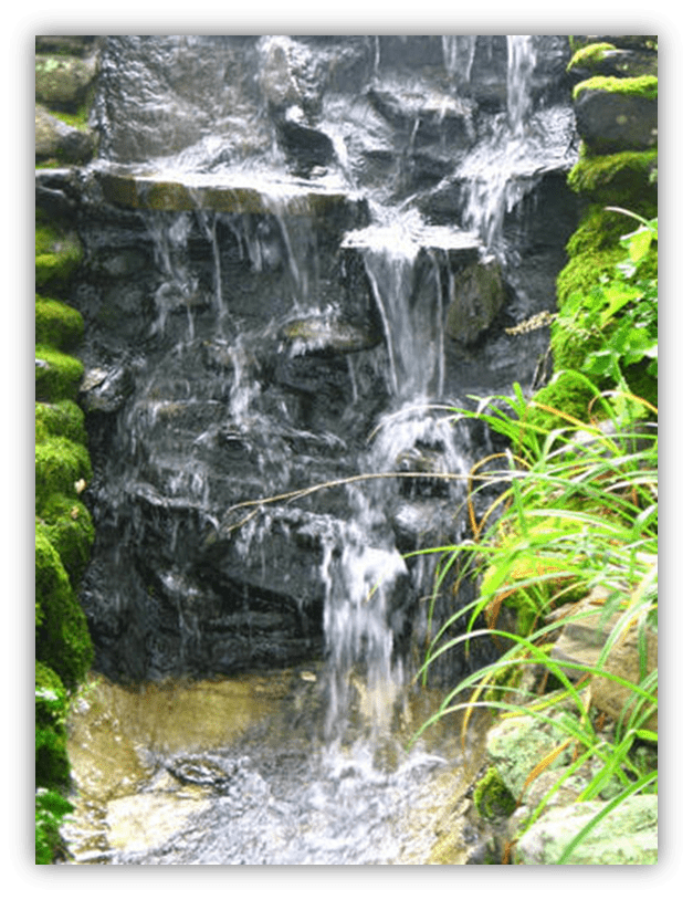 "Tranquil waterfall cascading over mossy rocks, surrounded by lush greenery."