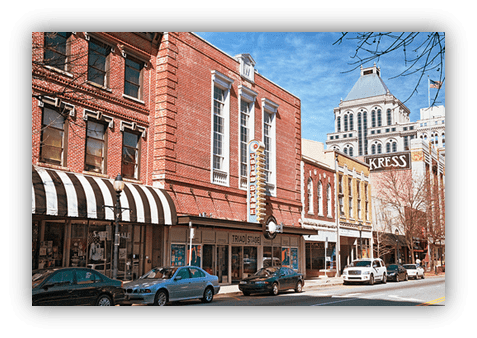 "Historic downtown street with brick buildings and storefronts."