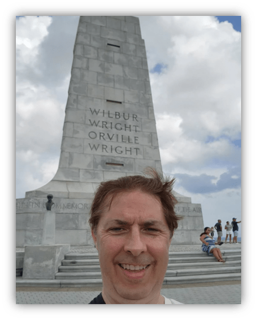 Selfie in front of the Wright Brothers National Memorial obelisk.