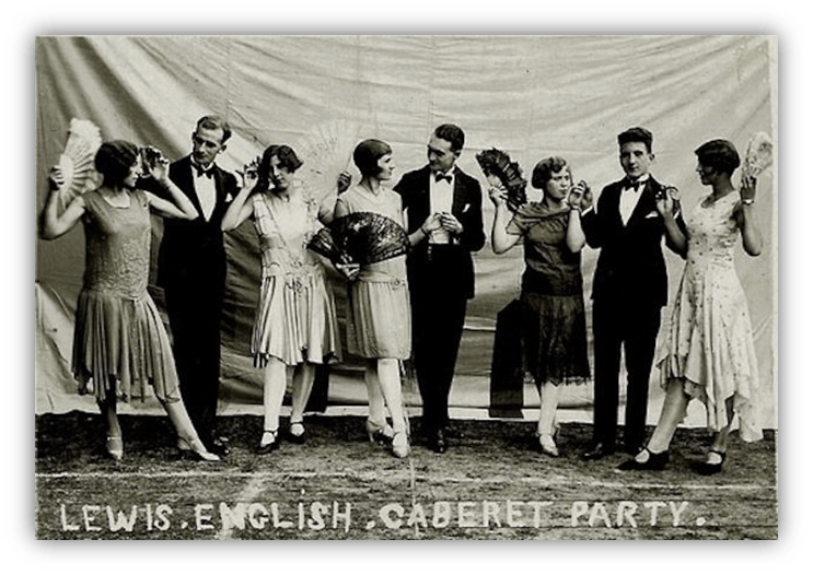 "Vintage cabaret party photo featuring elegantly dressed men and women with fans."