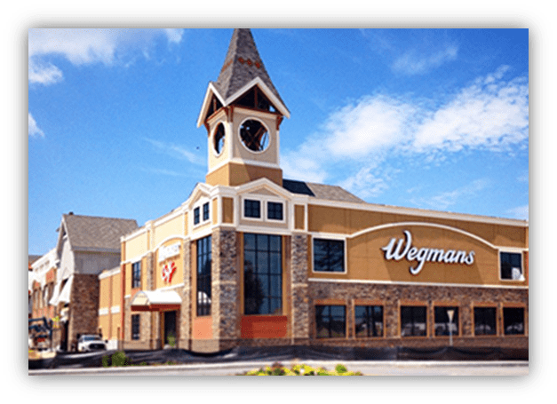 "Wegmans supermarket exterior with clock tower and blue sky."