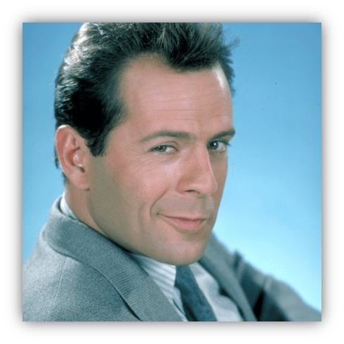 "Smiling man in a suit against a blue background."