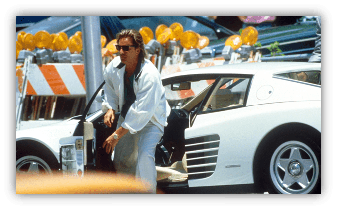 "Man exiting a white sports car near construction site with traffic barriers."