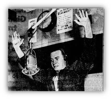 "Vintage radio host gesturing with hands at microphone in studio."
