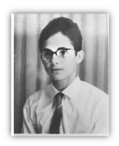 Black and white portrait of a young man wearing glasses and a tie.