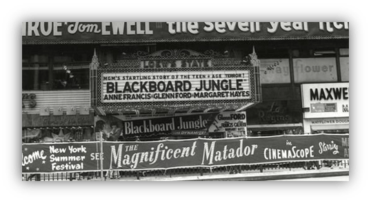 "Historic movie theater marquee featuring 'Blackboard Jungle' and 'The Magnificent Matador' in New York."