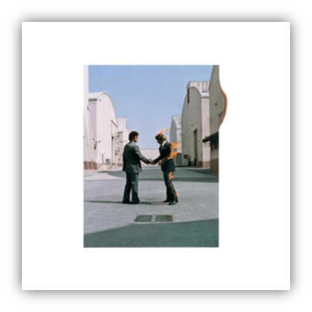 "Two men shaking hands in a surreal setting, one engulfed in flames."