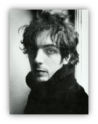 Black and white portrait of a young man with tousled hair, gazing thoughtfully.