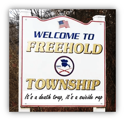 Alt text: "Welcome sign for Freehold Township with a quote about danger."