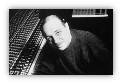"Black and white image of a male music producer at a mixing console."