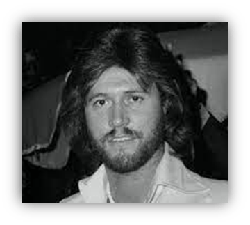 Black and white portrait of a man with long hair and a beard, wearing a white jacket.