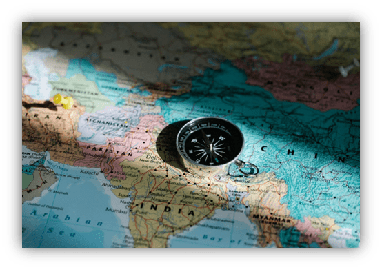 "Compass on a detailed map of Asia, highlighting China and India."