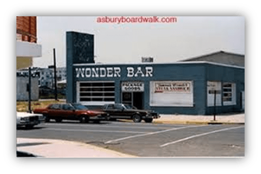 "Exterior view of Wonder Bar with classic cars parked outside."