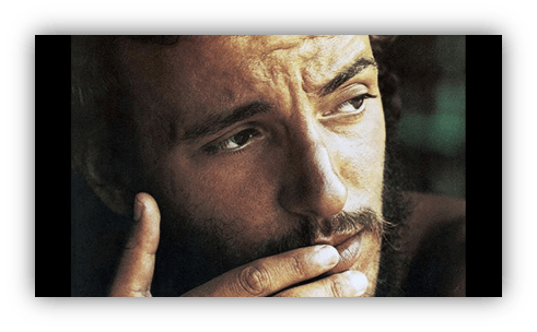 Thoughtful man with a beard, gazing intently.