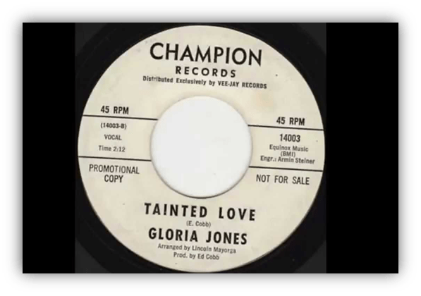 Alt text: "45 RPM vinyl record of 'Tainted Love' by Gloria Jones on Champion Records."