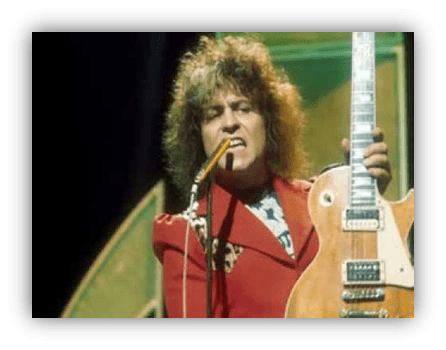 "Rock musician performing with electric guitar and microphone on stage."