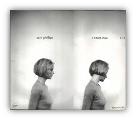 "Album cover of Sam Phillips' 'I Need Love' featuring a profile shot of a woman."