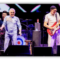 The Who performing live on stage with energetic musicians and vibrant visuals.