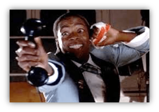 Man in a suit holding a telephone and a sandwich, looking excited.