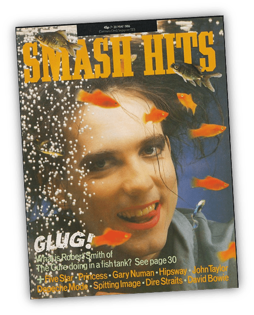 "Smash Hits magazine cover featuring Robert Smith of The Cure with fish in a tank, May 1986."