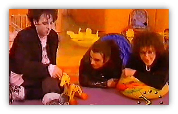 Three musicians play with colorful toys in a vibrant setting.
