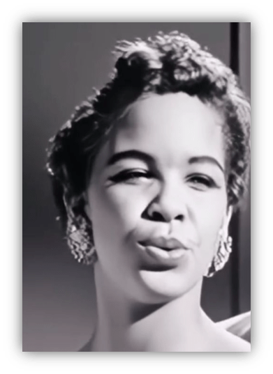 Classic black and white portrait of a woman with elegant earrings and a playful expression.